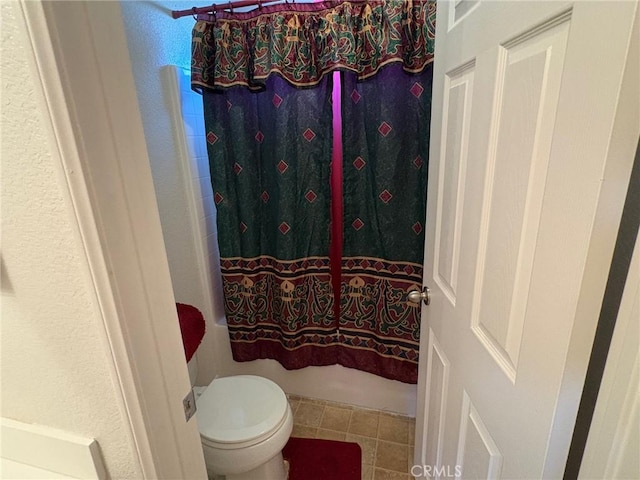 3324 Rosegold Ave, Rosamond, CA 93560 - full bathroom featuring toilet, shower / bathtub combination with curtain, and tile patterned flooring