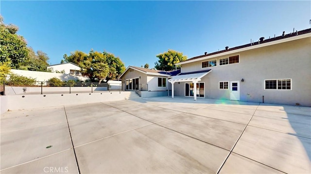 19201 Barrett Ln, North Tustin, CA 92705 - rear view of property featuring stucco siding and a patio area