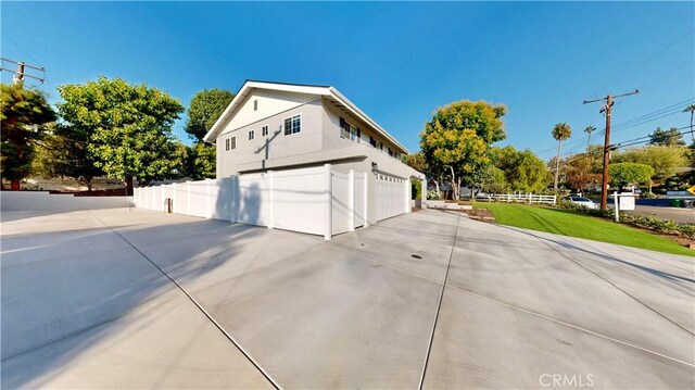 19201 Barrett Ln, North Tustin, CA 92705 - view of home's exterior featuring concrete driveway and an attached garage