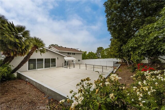 19201 Barrett Ln, North Tustin, CA 92705 - rear view of property with stucco siding and a patio
