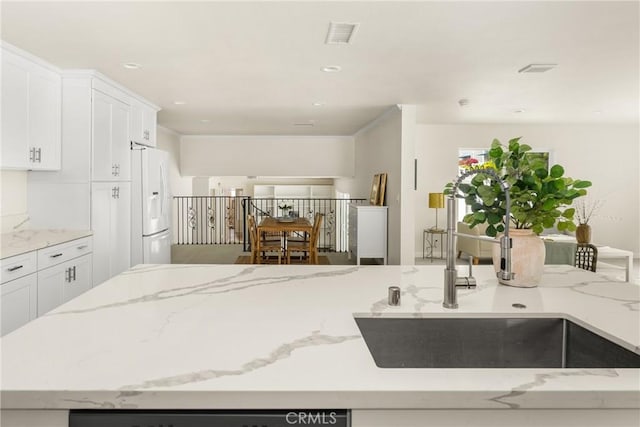 19201 Barrett Ln, North Tustin, CA 92705 - kitchen featuring white refrigerator with ice dispenser, white cabinets, light stone countertops, recessed lighting, and dishwashing machine