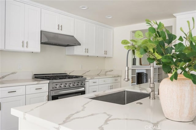 19201 Barrett Ln, North Tustin, CA 92705 - kitchen featuring under cabinet range hood, stainless steel gas stove, white cabinets, light stone counters, and recessed lighting