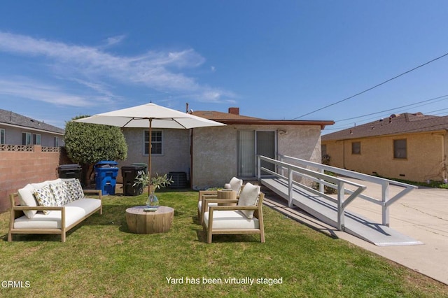 rear view of property featuring fence, an outdoor hangout area, stucco siding, a chimney, and a yard