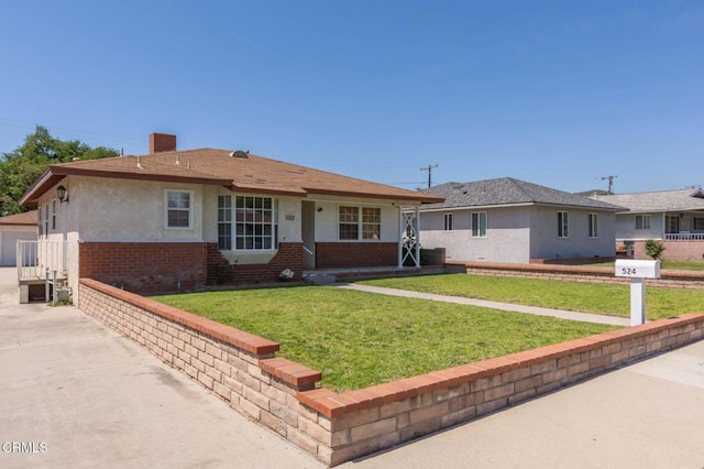 ranch-style house featuring brick siding, stucco siding, and a front yard