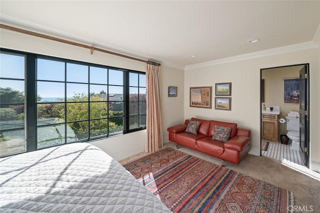 bedroom with baseboards, crown molding, and carpet floors