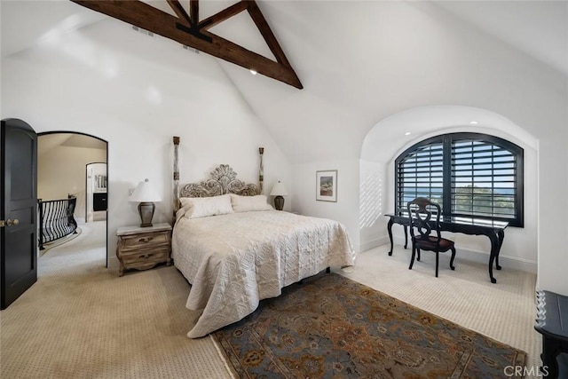 bedroom with high vaulted ceiling, arched walkways, light colored carpet, and beam ceiling