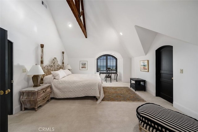 bedroom featuring visible vents, baseboards, vaulted ceiling, and light carpet