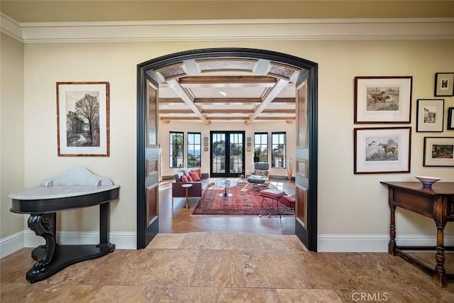 interior space with crown molding, beamed ceiling, arched walkways, coffered ceiling, and baseboards