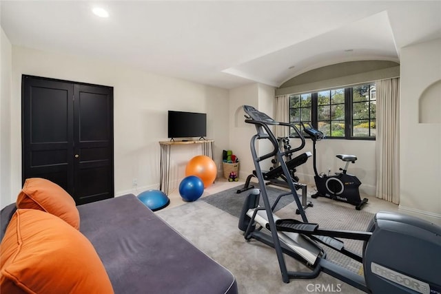 exercise room featuring carpet floors and baseboards