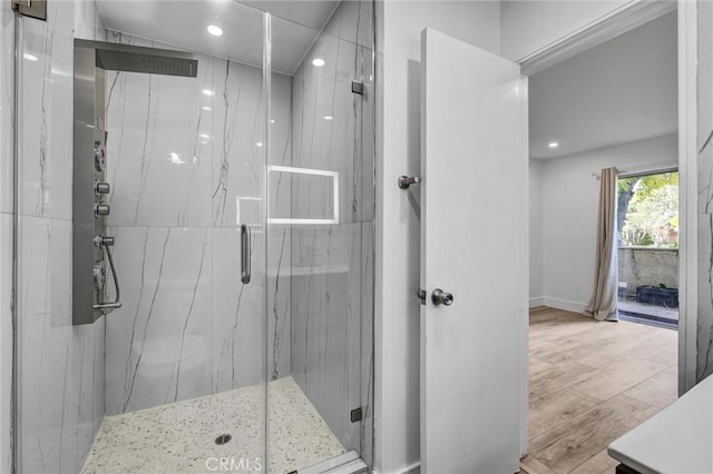 full bath featuring recessed lighting, baseboards, a marble finish shower, and wood finished floors