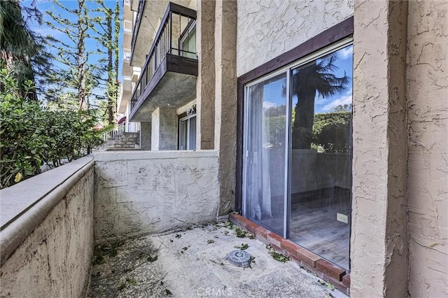 exterior space featuring a balcony and stucco siding