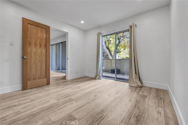 unfurnished room with baseboards, light wood finished floors, and recessed lighting