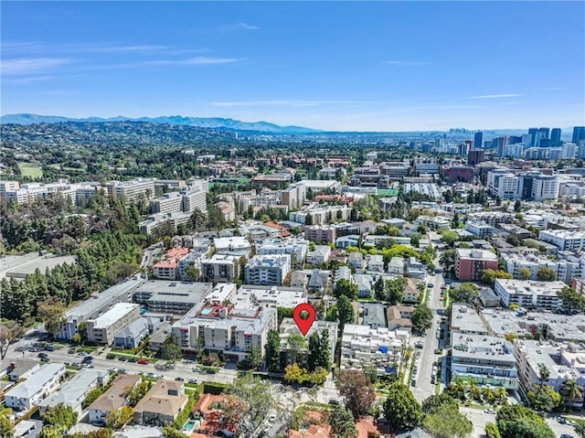 drone / aerial view featuring a mountain view and a view of city