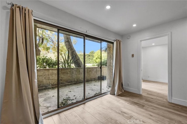 entryway with recessed lighting, light wood-type flooring, and baseboards