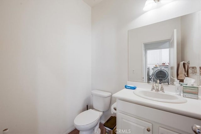 40925 Lacroix Ave, Murrieta, CA 92562 - bathroom with washer and dryer, vanity, baseboards, and toilet