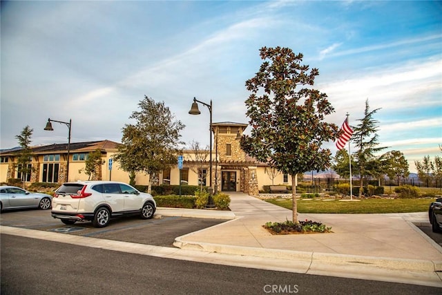 view of property featuring uncovered parking