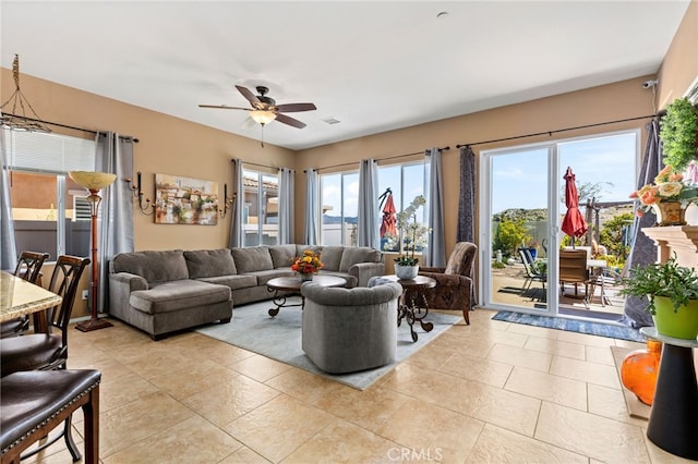 living room featuring light tile patterned flooring and ceiling fan