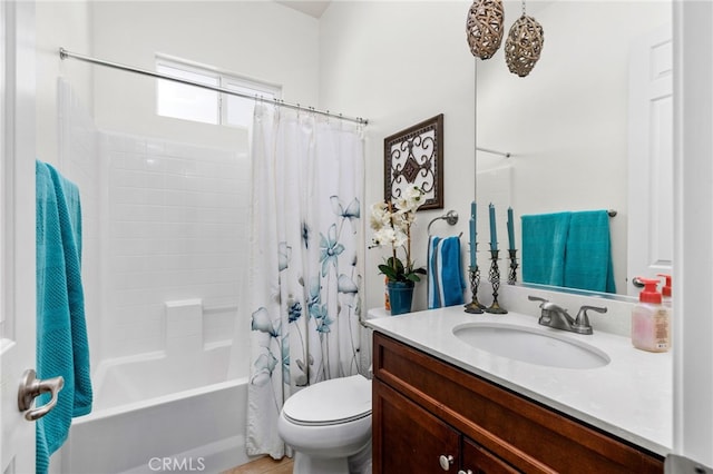 bathroom featuring shower / bath combo with shower curtain, vanity, and toilet