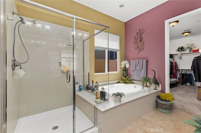 full bathroom with tile patterned flooring, a bath, visible vents, and a stall shower