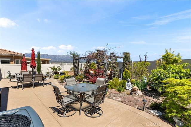 view of patio featuring a fenced backyard and outdoor dining area