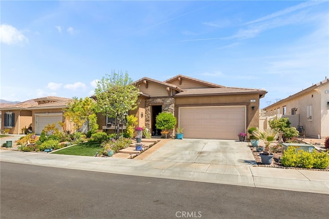 single story home featuring driveway, stone siding, an attached garage, and stucco siding