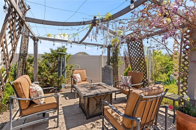 view of patio featuring fence and an outdoor fire pit