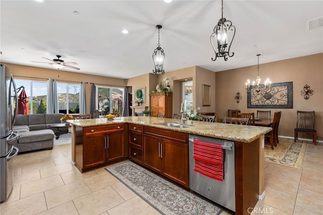 kitchen featuring a sink, open floor plan, light tile patterned flooring, and stainless steel appliances