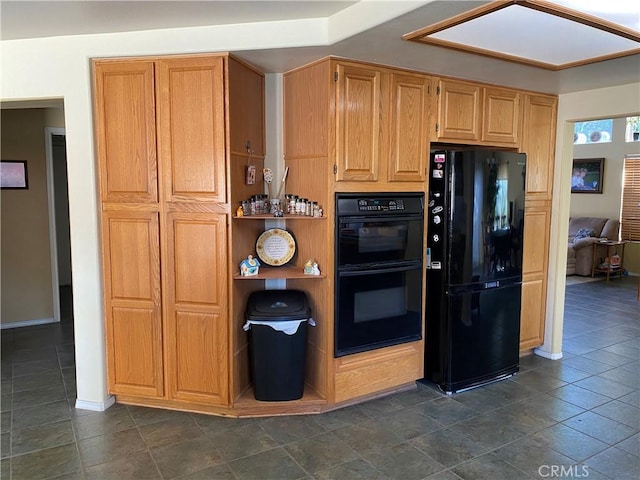 kitchen with baseboards and black appliances