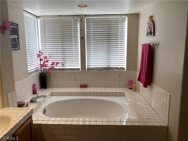 full bathroom with vanity and a garden tub