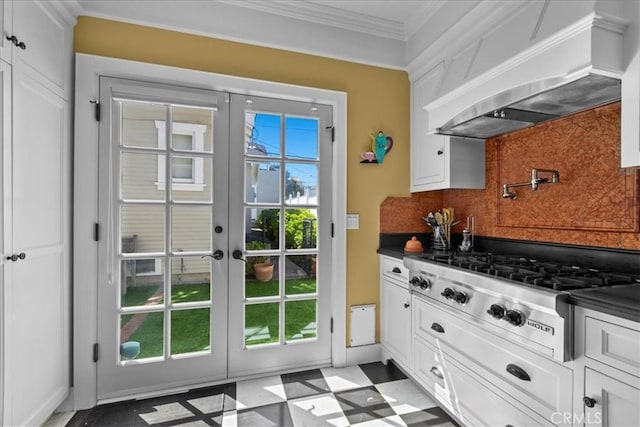 1239 S Patton Ave, San Pedro, CA 90731 - kitchen with custom exhaust hood, stainless steel gas stovetop, light floors, french doors, and dark countertops