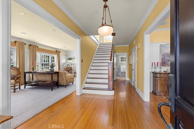 1239 S Patton Ave, San Pedro, CA 90731 - foyer entrance with stairs, light wood finished floors, and crown molding