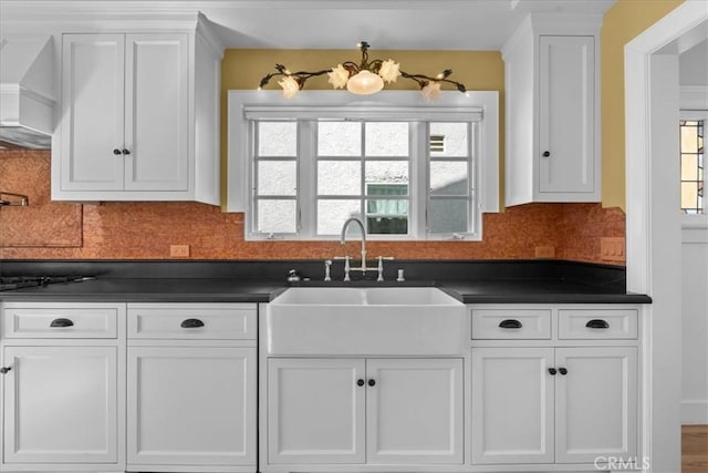 1239 S Patton Ave, San Pedro, CA 90731 - kitchen featuring dark countertops, white cabinets, and backsplash