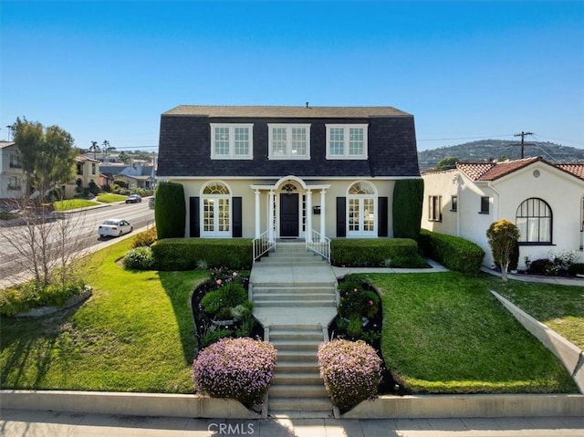 1239 S Patton Ave, San Pedro, CA 90731 - colonial inspired home featuring french doors, a shingled roof, a front yard, and stucco siding