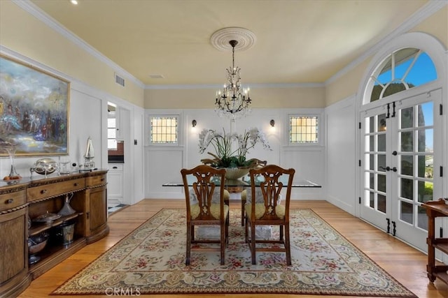 1239 S Patton Ave, San Pedro, CA 90731 - dining area featuring a chandelier, light wood finished floors, french doors, and crown molding