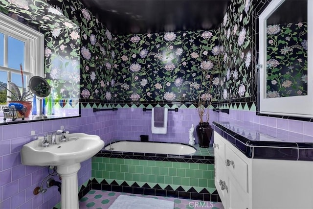 1239 S Patton Ave, San Pedro, CA 90731 - full bath with wallpapered walls, a bath, tile walls, a wainscoted wall, and tile patterned floors