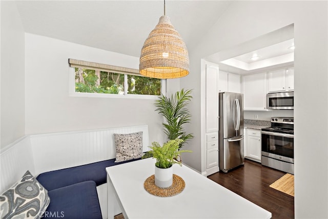 195 Hartford Dr Unit 111, Newport Beach, CA 92660 - dining area featuring wainscoting, vaulted ceiling, and dark wood finished floors