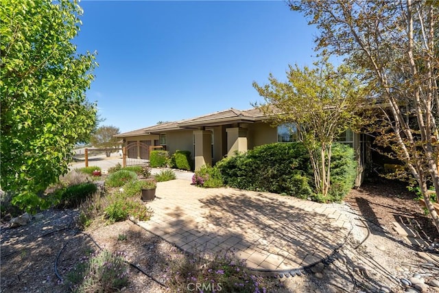 view of front of property with fence and stucco siding