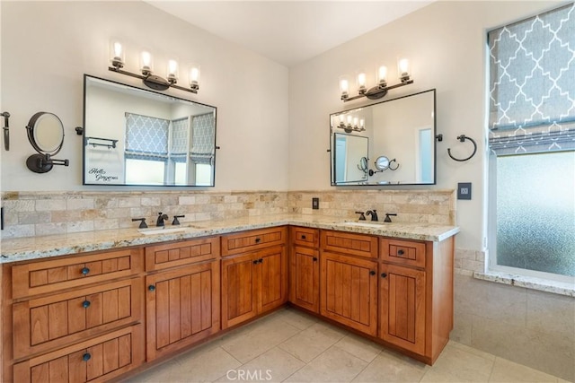 bathroom with double vanity, tile patterned floors, and a sink