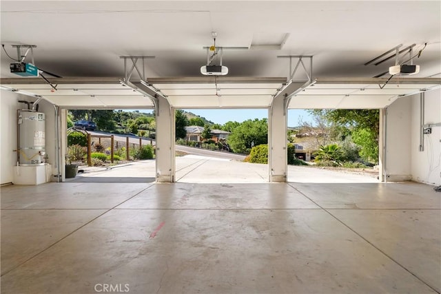 garage featuring gas water heater and a garage door opener