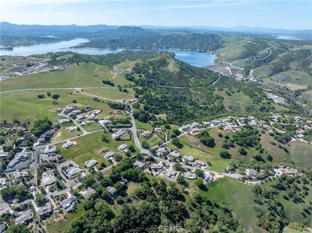 drone / aerial view featuring a water and mountain view