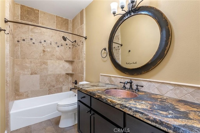 bathroom with a chandelier, vanity, shower / tub combination, and toilet