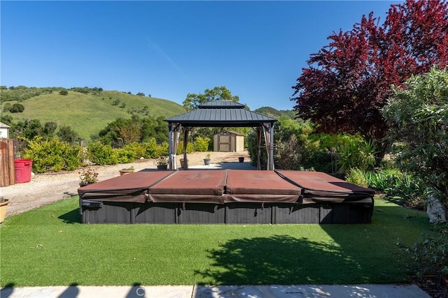 view of yard featuring a gazebo, a covered hot tub, and a mountain view