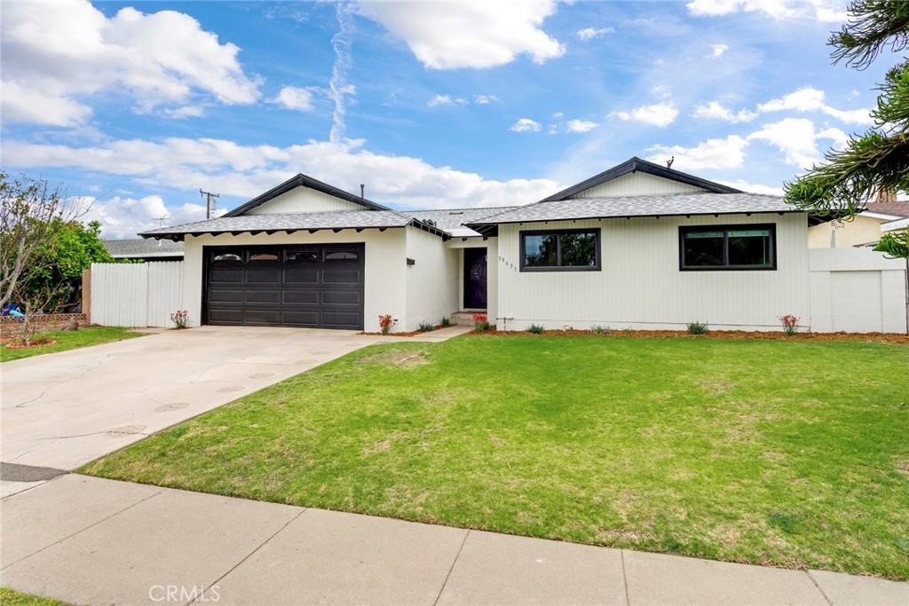 15631 Pacific St, Tustin, CA 92780 - ranch-style house with an attached garage, fence, driveway, and a front yard