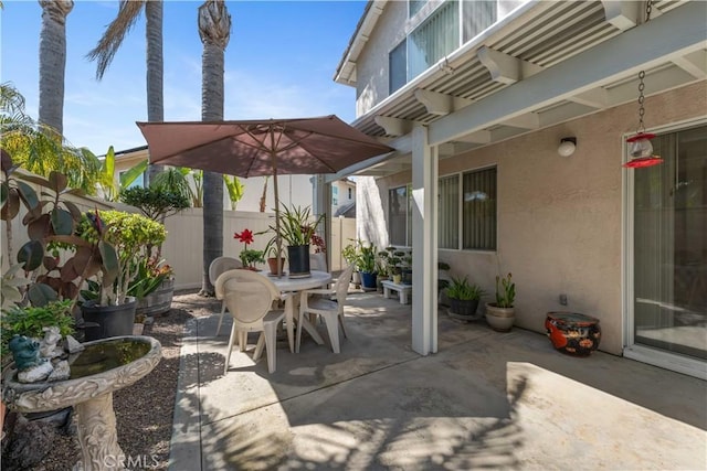 view of patio / terrace featuring fence and outdoor dining area