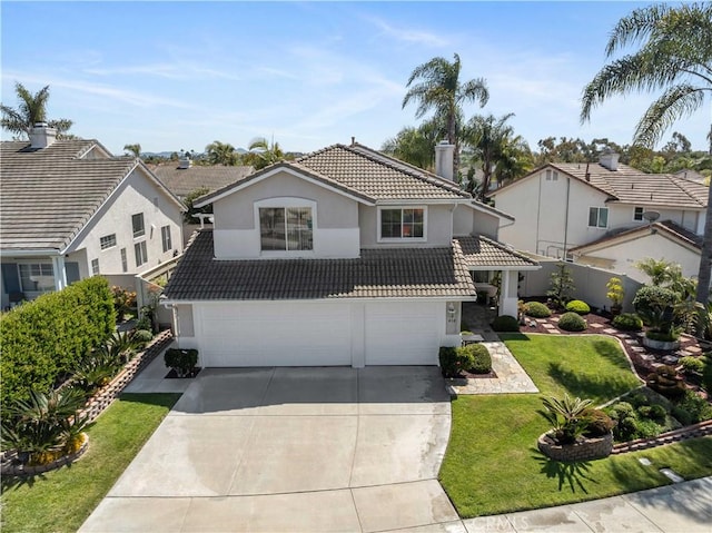 traditional-style home featuring a front yard, a tile roof, a chimney, a garage, and concrete driveway