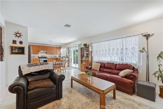 living room with light tile patterned floors and visible vents