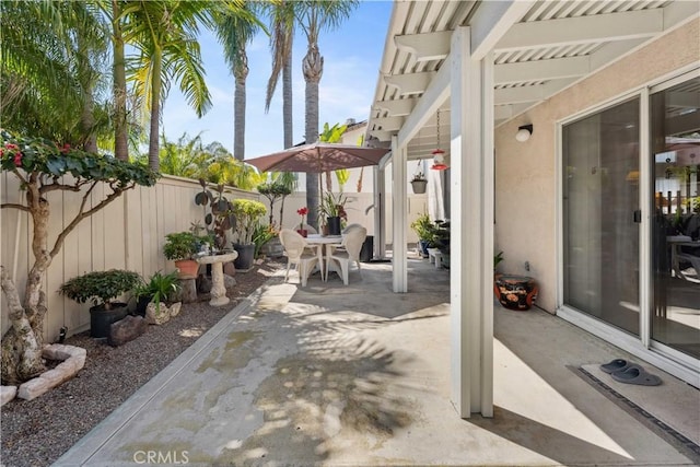 view of patio with a fenced backyard and outdoor dining space