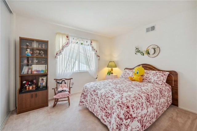 carpeted bedroom featuring visible vents and a closet