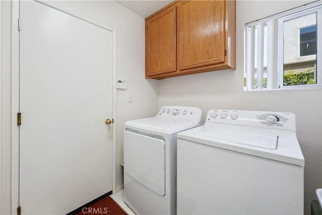laundry room with independent washer and dryer and cabinet space