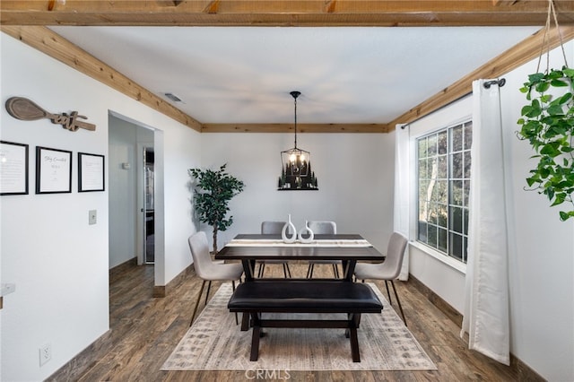 dining room featuring baseboards, dark wood-type flooring, a chandelier, and visible vents